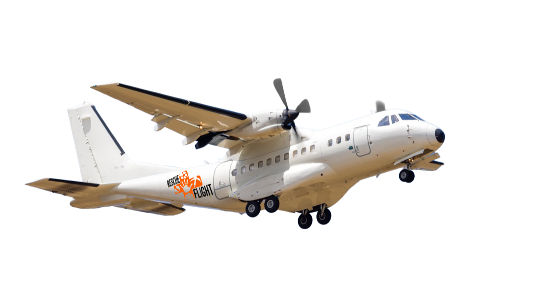 A CN235 transport aircraft climbing after takeoff